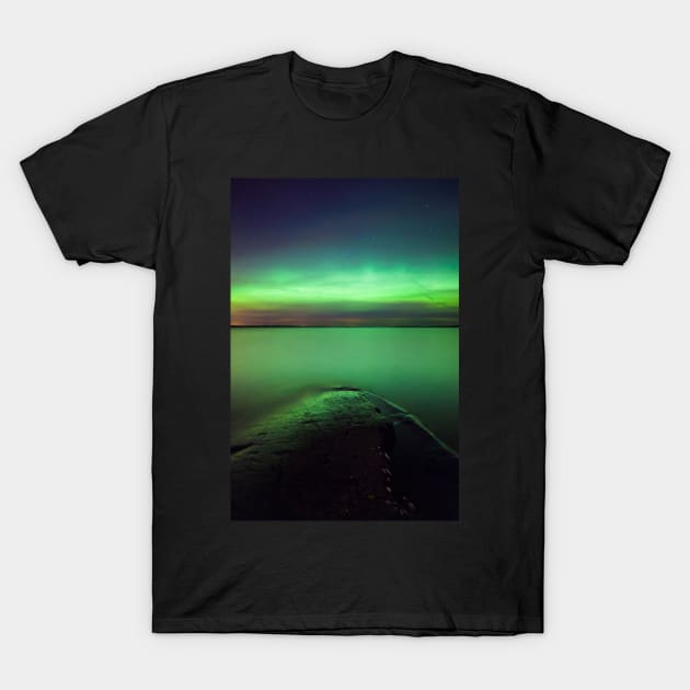 Northern lights glow over lake T-Shirt by Juhku